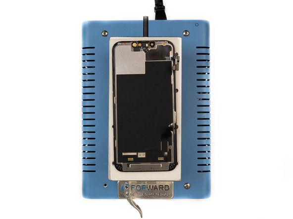 Heat the screen at 100 degrees celsius. We're doing this to loosen the glue holding the proximity sensor flex cable to the screen.