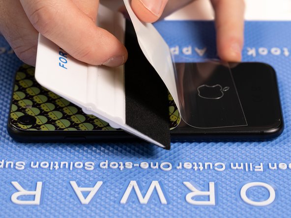With your application tool slowly slide it along the film until you reach the end of the phone.