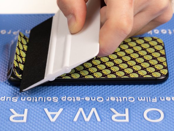 With your application tool slowly slide it along the film until you reach the top of the phone.