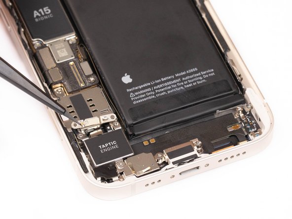 Using tweezers or your fingers, remove the remove the taptic engine cable connector bracket