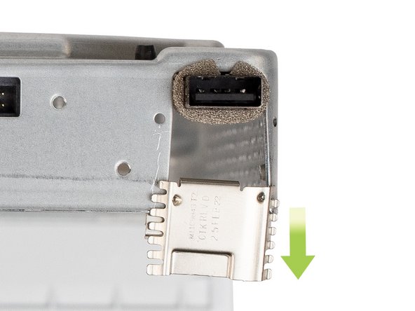 The locking clip is located on the front-left corner of the chassis. To remove the clip, slide it away from the chassis.