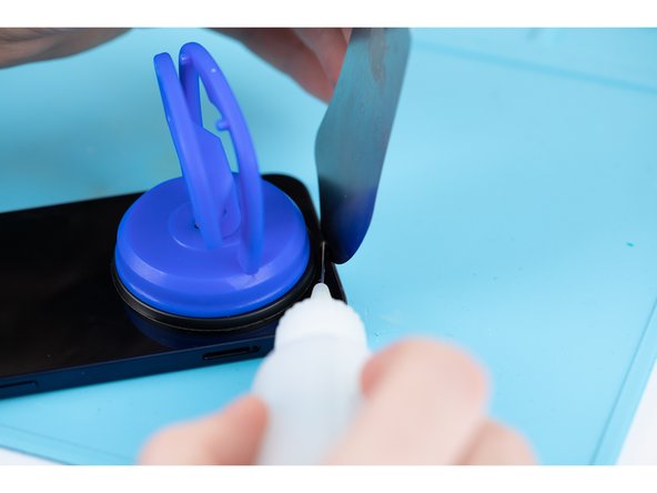 Using a pry tool or plastic card, begin prying the bottom edge of the phone open. You can use some IPA to help loosen the screen if you're struggling.