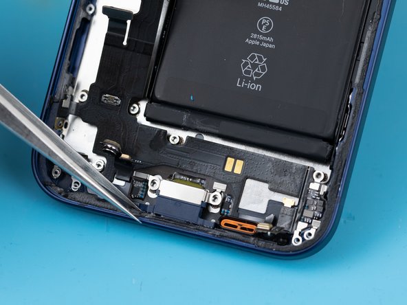 Using a tweezer, slowly pry the charge port away from the phone case.