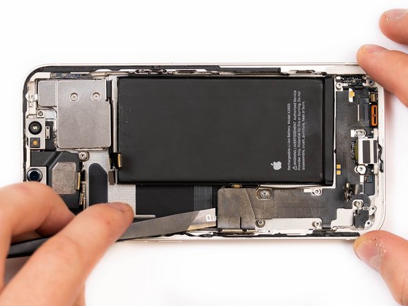 Begin prying the start of the charge port flex up with a spudger.