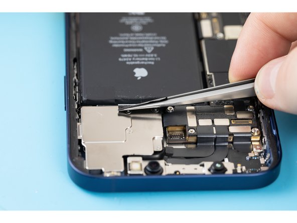 Pull down the adhesive tabs at the top of the battery.