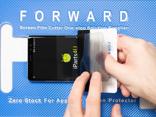 With your application tool slowly slide it along the film until you reach the top of the phone.