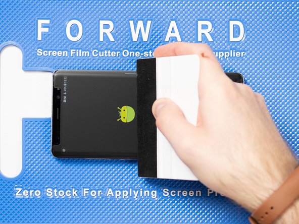 Run your application tool across the entire front film one last time to smoothe out any bubbles and ensure it's fully stuck down.