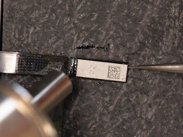 Heat the chip with the hot air nozzle and gently nudge the side of the IC with tweezers, you'll know when it's bonded when it bounces back into place.