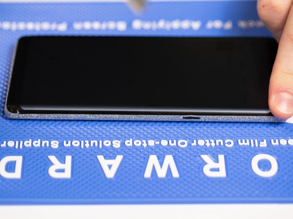 Run your finger back and forth across the edges to ensure the film is stuck down.