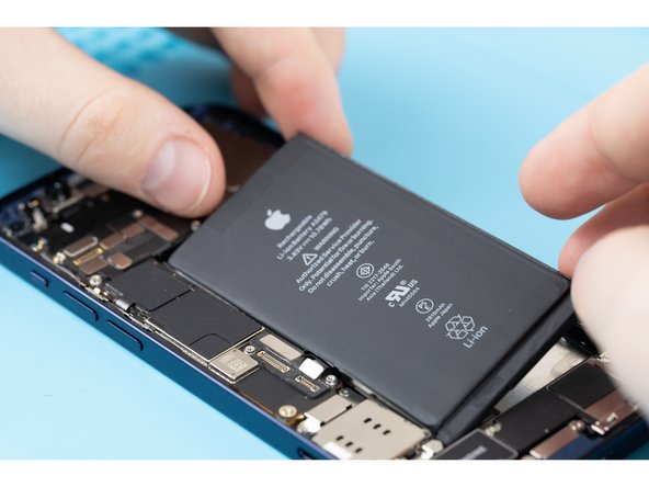 Firmly press the top and bottom of the battery into place. This will help the adhesives stick to the rear case.