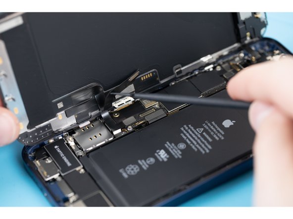 Disconnect the display cable with a spudger or fingernail.