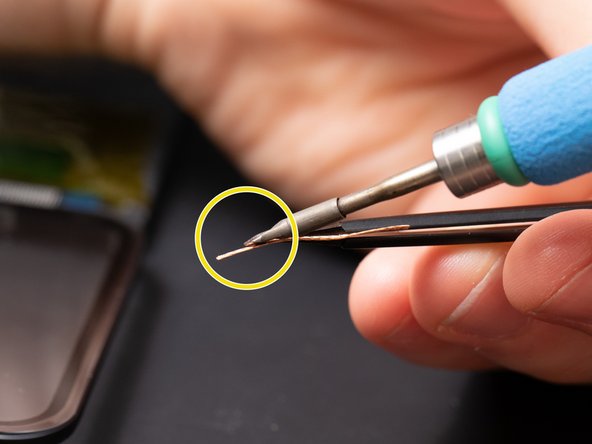 As you can see in this example we are holding the soldering iron on a slant to maximize the heat transfer to the solder wick.