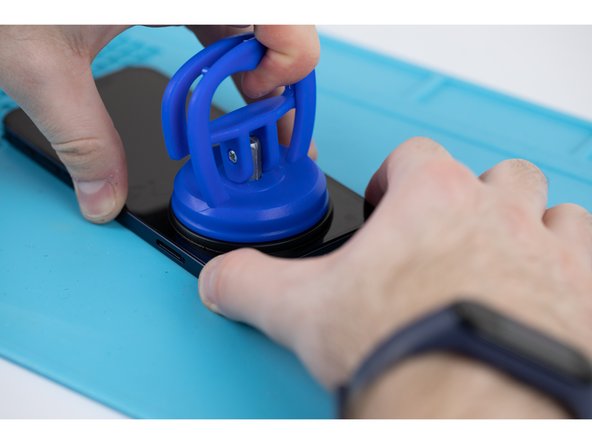 Pull the suction cup away from the phone, this will create a gap between the front panel and rear case.