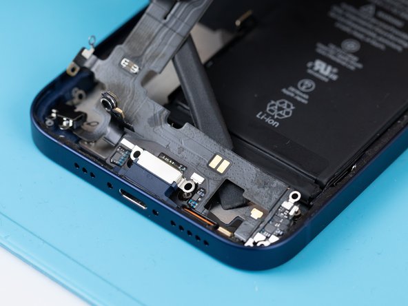 Use a spudger to lift the charge port flex away from the phone case.