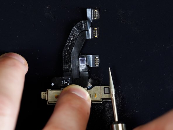 Grind the back of the metal bracket on the front camera enough to  create an opening for a prying tool.