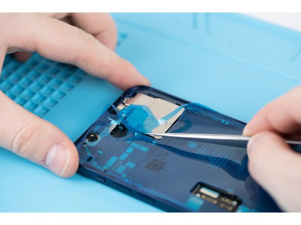 Use tweezers to peel away the protective cover from the adhesive.