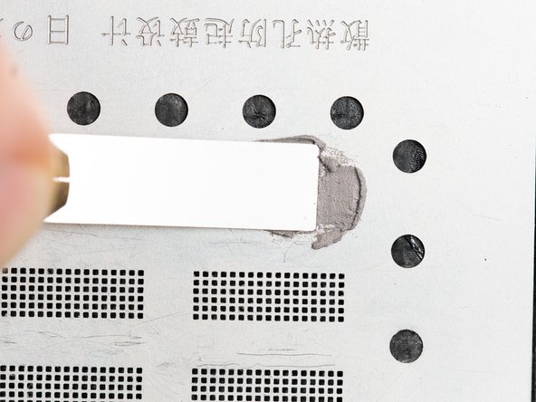 Rub the dried solder paste back and forth on top of the stencil to fill in all of the holes.