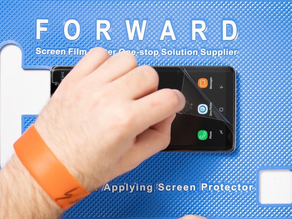 Grip the peelable tab with tweezers or your fingers and peel the protective layer away from the film.