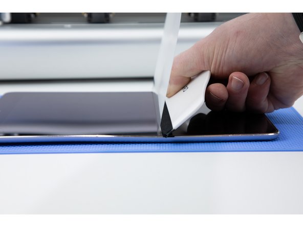 Firmly press your application tool onto your iPad and pull back the film to meet with your application tool.