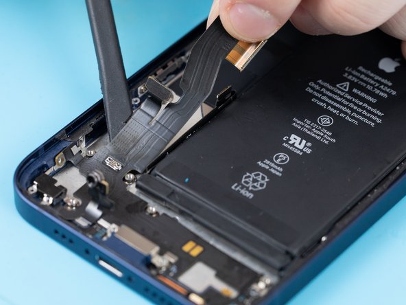 Begin prying the start of the charge port flex up with a spudger.