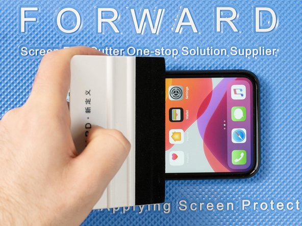 Run your application tool across the entire front film one last time to smoothe out any bubbles and ensure it's fully stuck down.