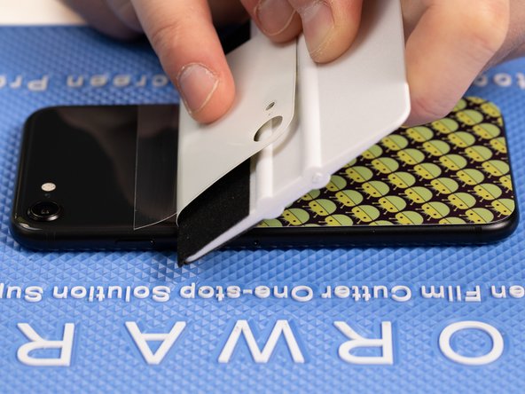 With your application tool slowly slide it along the film until you reach the top of the phone.