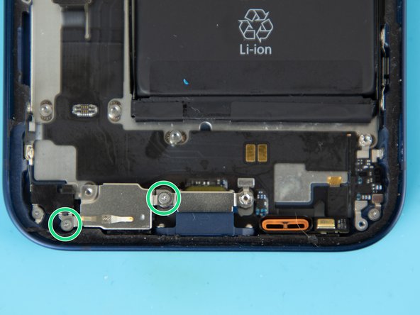 There's a protective cover resting over two microphones. Remove the screws securing the protective cover.