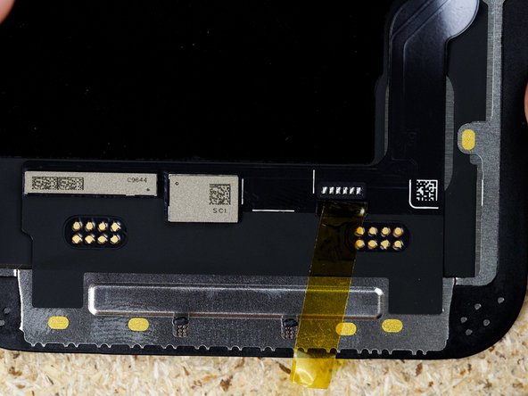 Peel off the cover up sticker thats covering the solder pads on the display. We used Kapton tape to keep the sticker in place.