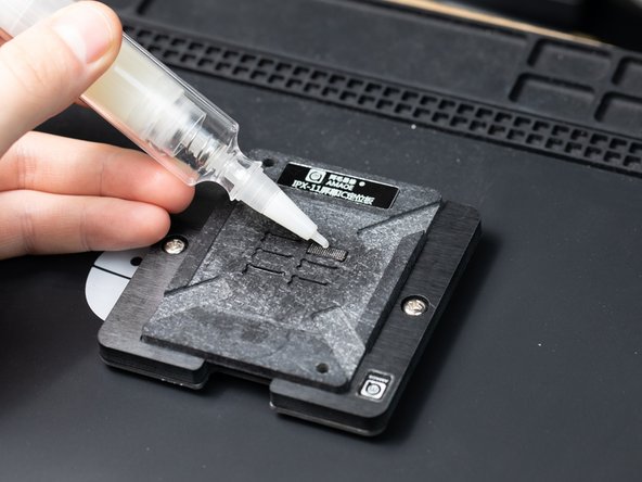 Remove the stencil and add a drop of flux to the chip.