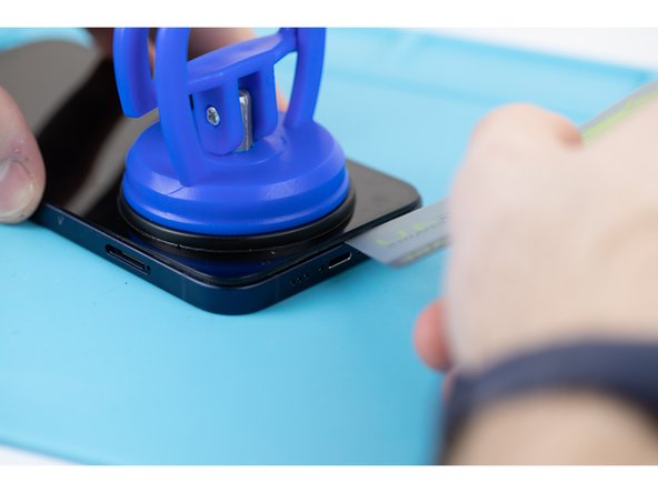 Continue prying the phone open along the left and right side.