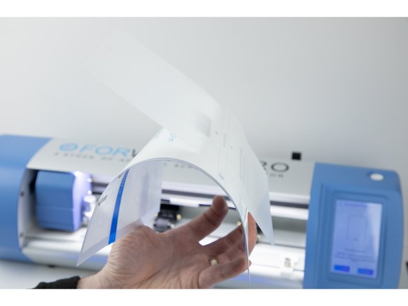 Slowly peel away each side of the film until they meet in the middle and you're able to peel the whole film off.