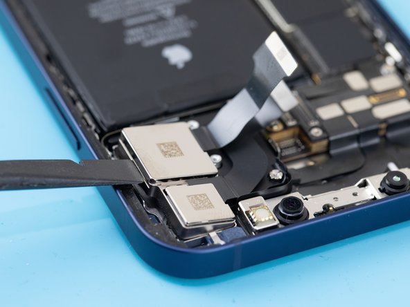 Using a spudger, pry the rear cameras out of their socket and remove them with a tweezer.