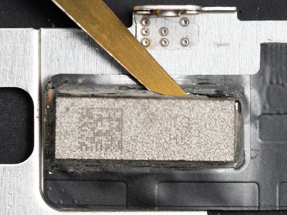 Once you've managed to create an opening at one of the corners of the chip you'll need to continue prying at an angle underneath the entire chip.