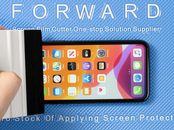 Run your application tool across the entire front film one last time to smoothe out any bubbles and ensure it's fully stuck down.