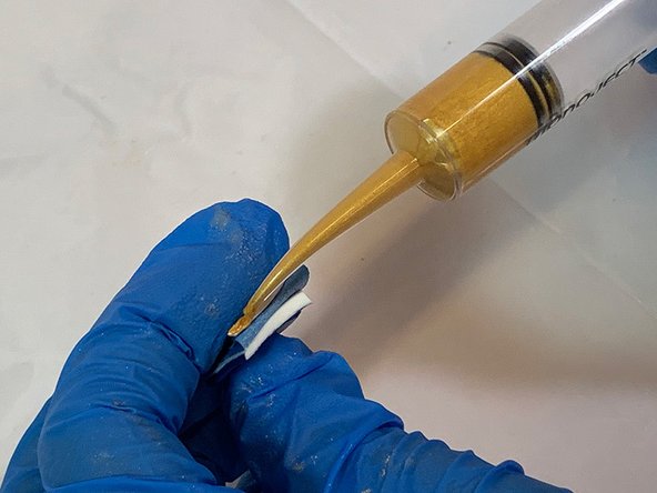 Fold the tape in half to expose the two broken sides. Apply epoxy to both broken edges and slowly fold back together.