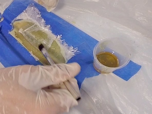 It’s important to apply only enough mixed epoxy to saturate the cloth. Cured epoxy is very hard to sand, so you don’t want a thick buildup.