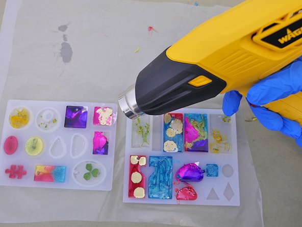 To pop any small air bubbles, wave the heat gun (on low setting) quickly, back and forth above the surface, and keep it moving. This only takes a couple of seconds.