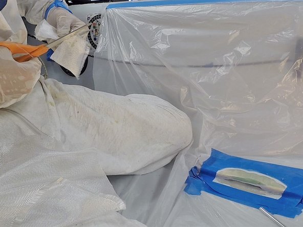 To repair the fiberglass, you will fill the damaged area with successively smaller pieces of fiberglass cloth, one ply at a time, wetting out each one with the mixed, unthickened epoxy.