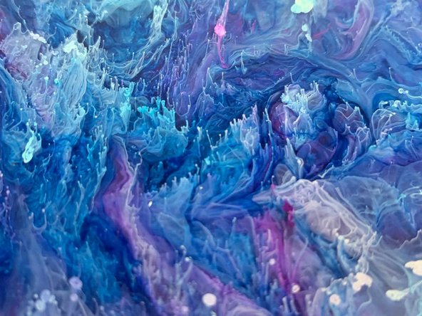 For a droplet effect, first, drop the colors you want into the epoxy in the mold. Then add white ink drops on top (white is heavier and sinks the colors). See second image.