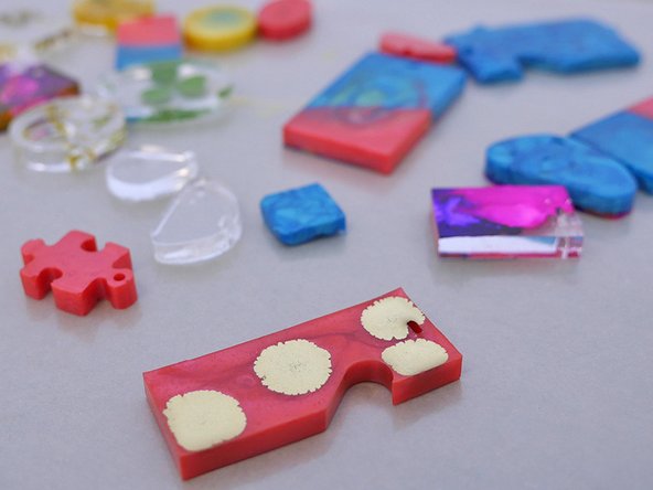 To remove the jewelry pieces from the mold, press firmly against the back side of the mold. The silicone molds provided in the TotalBoat Epoxy Jewelry Kit will create a glossy finish.