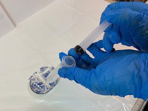Remove the plunger from one of the  epoxy syringes.