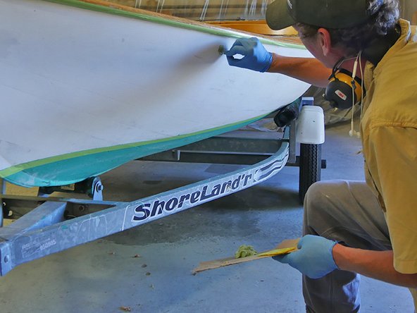 Use a putty knife or spreader to apply mixed TotalFair to fill small dings and gouges. Before sanding, allow to dry completely.