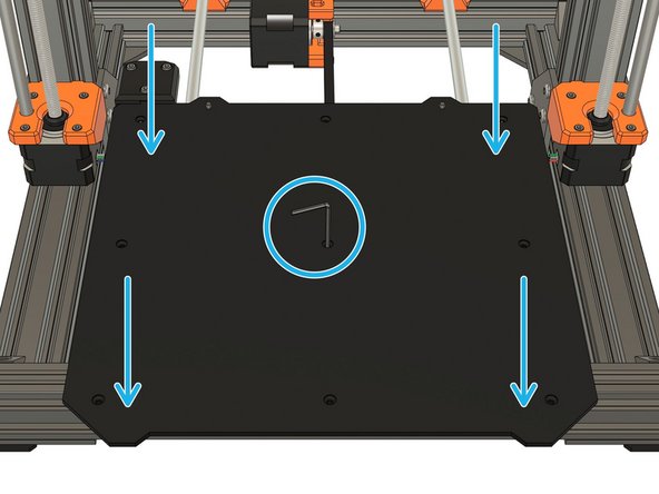 Place the heated bed with the hex key on the Y carriage. Align the bed with the spacer and the centeral hole of the Y carriage using the hex key.