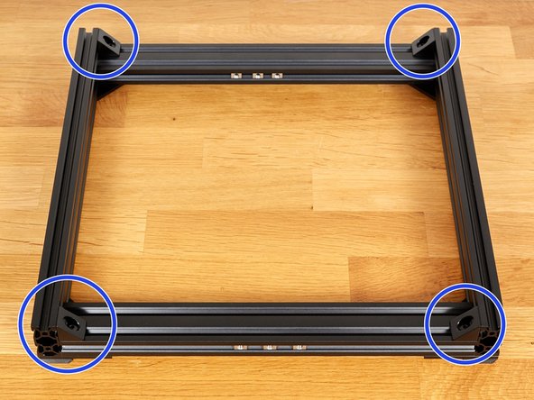 Attach an angle corner, using 2x M5x8 screws at each corner. Do not tighten them fully yet!