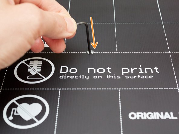 Take your heated bed and insert the hex key in the centeral hole.