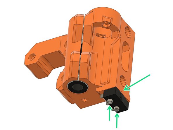 MK2(S) or MK2.5(S) only: Use two M2x12 screws to attach the x-endstop switch. Ensure the correct orientation of the switch. The microswitch should be oriented so that it is closest to the v-notch in the printed part.