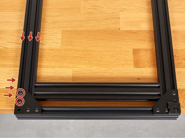 Place the assembly at the end of a table, as shown, so that the two 331mm extrusions lie flat on the surface.