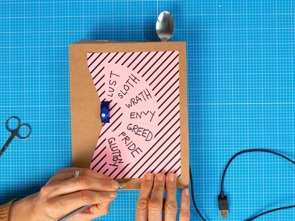 The dial will be secured to the box with two paper clips.