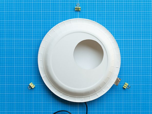 Place the front plate on top of the back plate. The electronics will be fully covered and the white lighting area in the circular window will be clear.