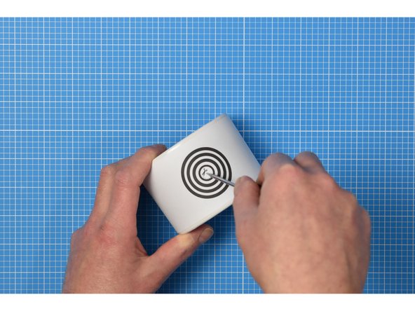 Using a bradawl or other sharp point, carefully make a hole in the center of the concentric circles on the wrapper.